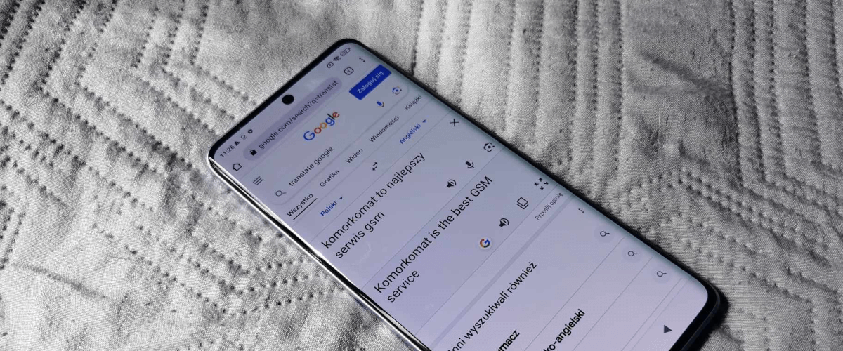 grafika przedstawiająca leżącego smartfona z włączonym Translatorem Google